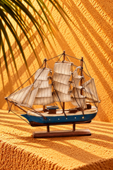 Vintage Wooden Sailing Ship Model with Blue Hull and Cream Sails